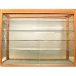 Vintage Dinky Toys style display or retail cabinet with glass shelves and sliding door