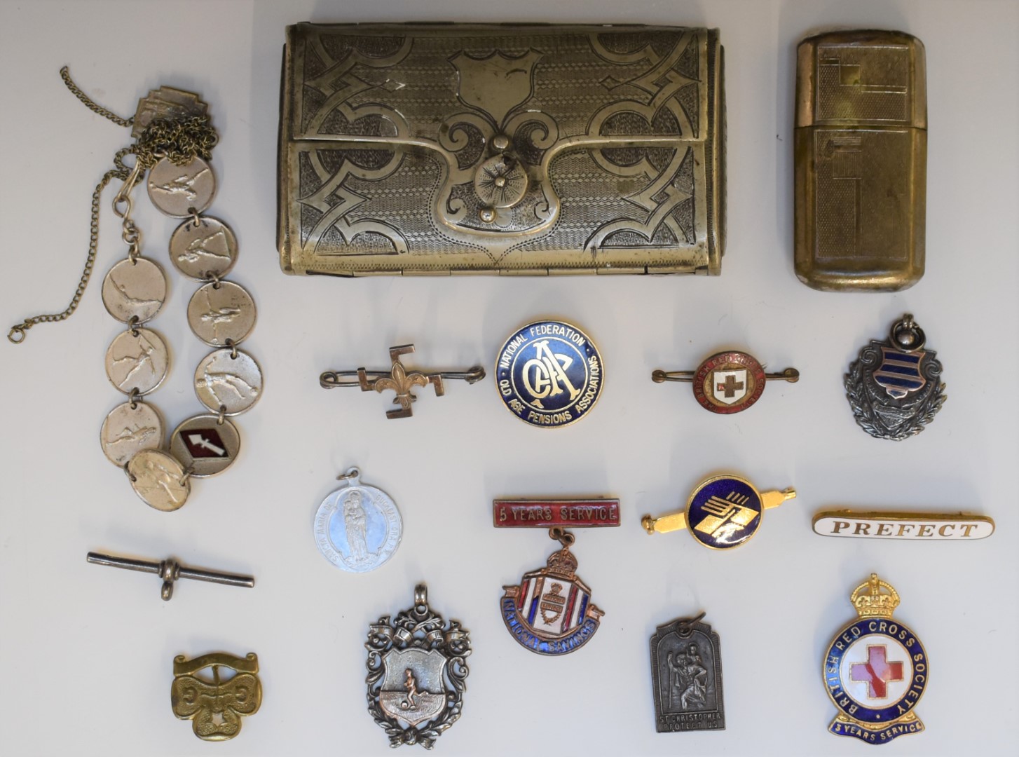 Small collection of badges including an early swastika, Scouts badge stamped silver to reverse,