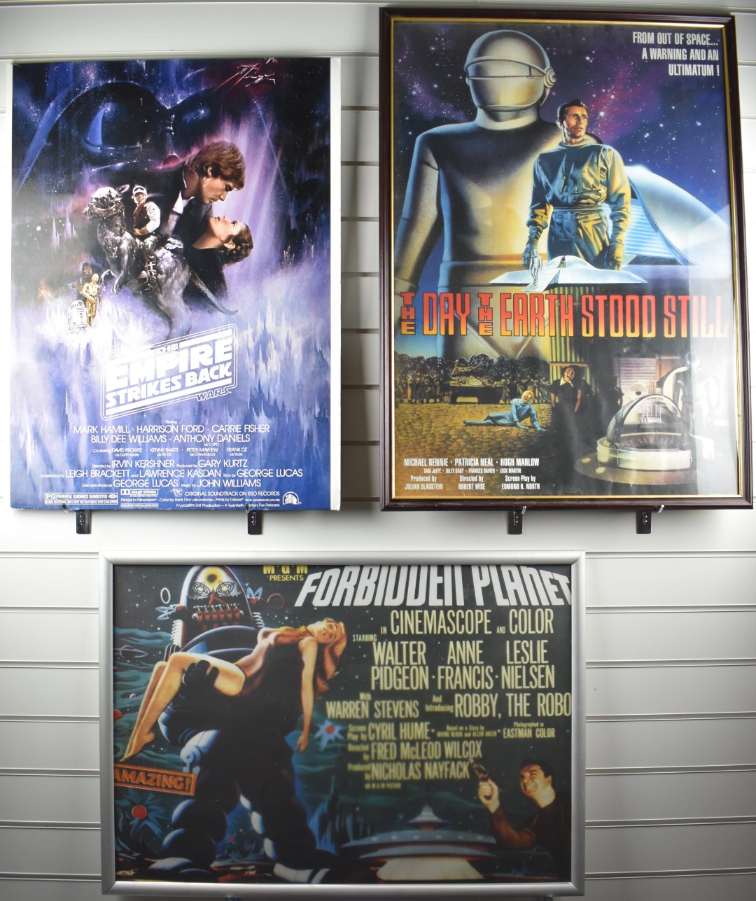 Three framed film posters for Star Wars Empire Strikes Back, Forbidden Planet and The Day The