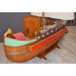 A scratch built model of a Roman ship or quadriremes with single mast, castellated bridge, oars,