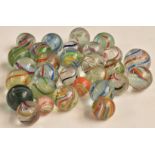 Twenty-nine vintage glass marbles all with multi-coloured latticinio decoration, largest 23mm in