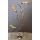 Shopfitting / haberdashery vintage glove display stand with four wooden articulated hands on a