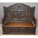 Victorian carved oak settle with figural decoration and lion mask finials to arms, W154 x H136