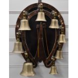 Campanology set of eight bells on horseshoe wall bracket