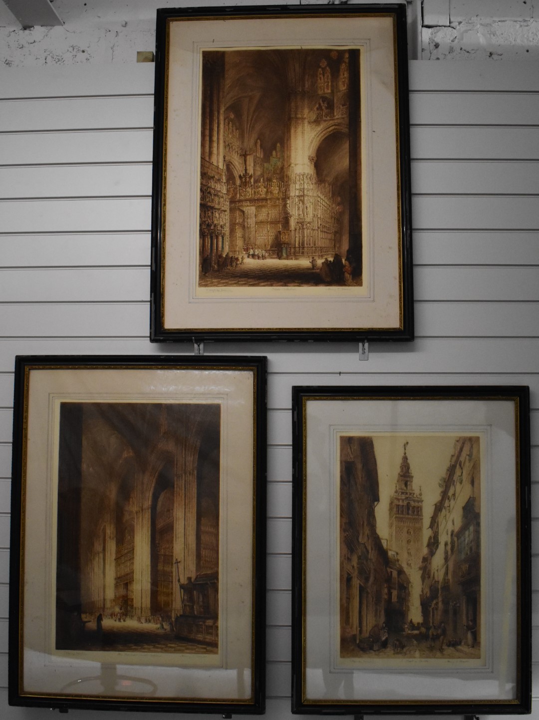 J Alphege Brewer, three etchings, two interior scenes of cathedrals including Seville and Toledo,