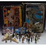 A collection of vintage Star Wars toys including The Millennium Falcon, AT-AT Walker, AT-ST, X-