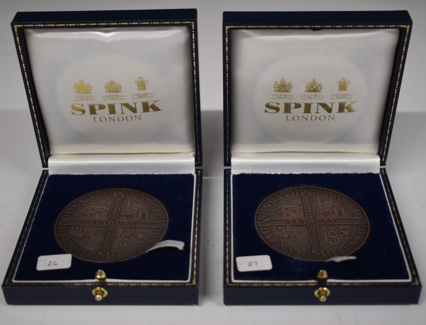 Two Armes of Tetbury bronze Millennium medallion coins, in Spink cases