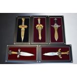 A set of eight dragon themed knives on purpose made plaques by Michael Whelan, including Vengeance