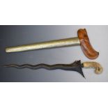 Ornately carved ivory handled Kris dagger with 35cm blade and sheath. PLEASE NOTE ALL BLADED ITEMS