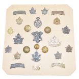 A carded display of approximately twenty five WW1 Canadian Army insignia including artillery