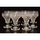 A set of ten cut and engraved glass drinking glasses, each 14cm tall.