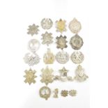 A collection of approximately twenty British Army Scottish headdress badges including the