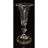 An 18thC wine glass with flared bowl, doubled knopped stem and folded foot, 13cm tall.