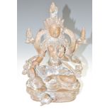 19thC Tibetan bronze figure of Vishnu with four arms, seated and holding a conch shell, one foot