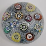 Perthshire millefiori glass paperweight with twelve canes including silhouette canes with a penguin,