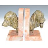 After Prosper Lecourtier (French 1851-1924) Art Deco pair of pink onyx and bronzed spelter bookends,