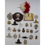 Small collection of British Army cap badges including Royal Artillery, Argyll & Sutherland