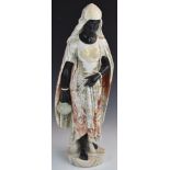 A finely carved variegated marble figurine of North African water carrier in black and veined