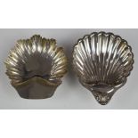 Two hallmarked silver shell shaped dishes, both raised on three ball feet, one Victorian, London