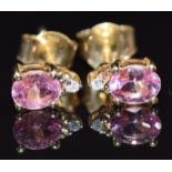 A pair of 10k gold earrings set with an oval pink sapphire and diamond to each, 1.1g