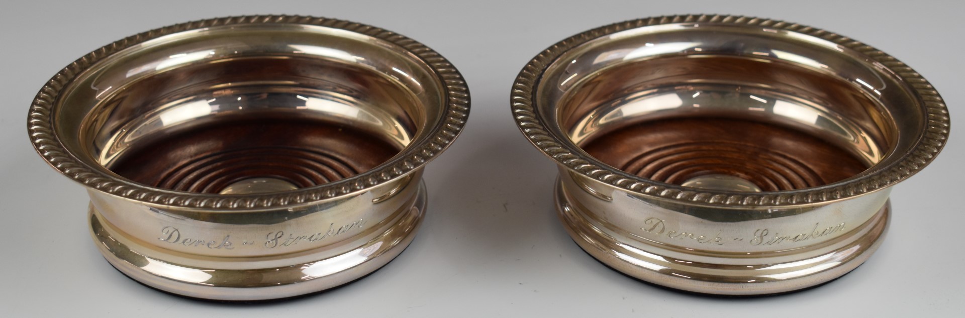 Modern pair of hallmarked silver wine coasters, Birmingham 2001, maker Barker Ellis Silver Co,