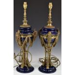 Pair of porcelain and bronze / brass Royalcore pedestal table lamps with ram mask and swag