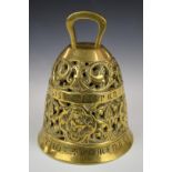 A heavy relief mould and pierced brass bell with figural decoration and Latin script, H19cm