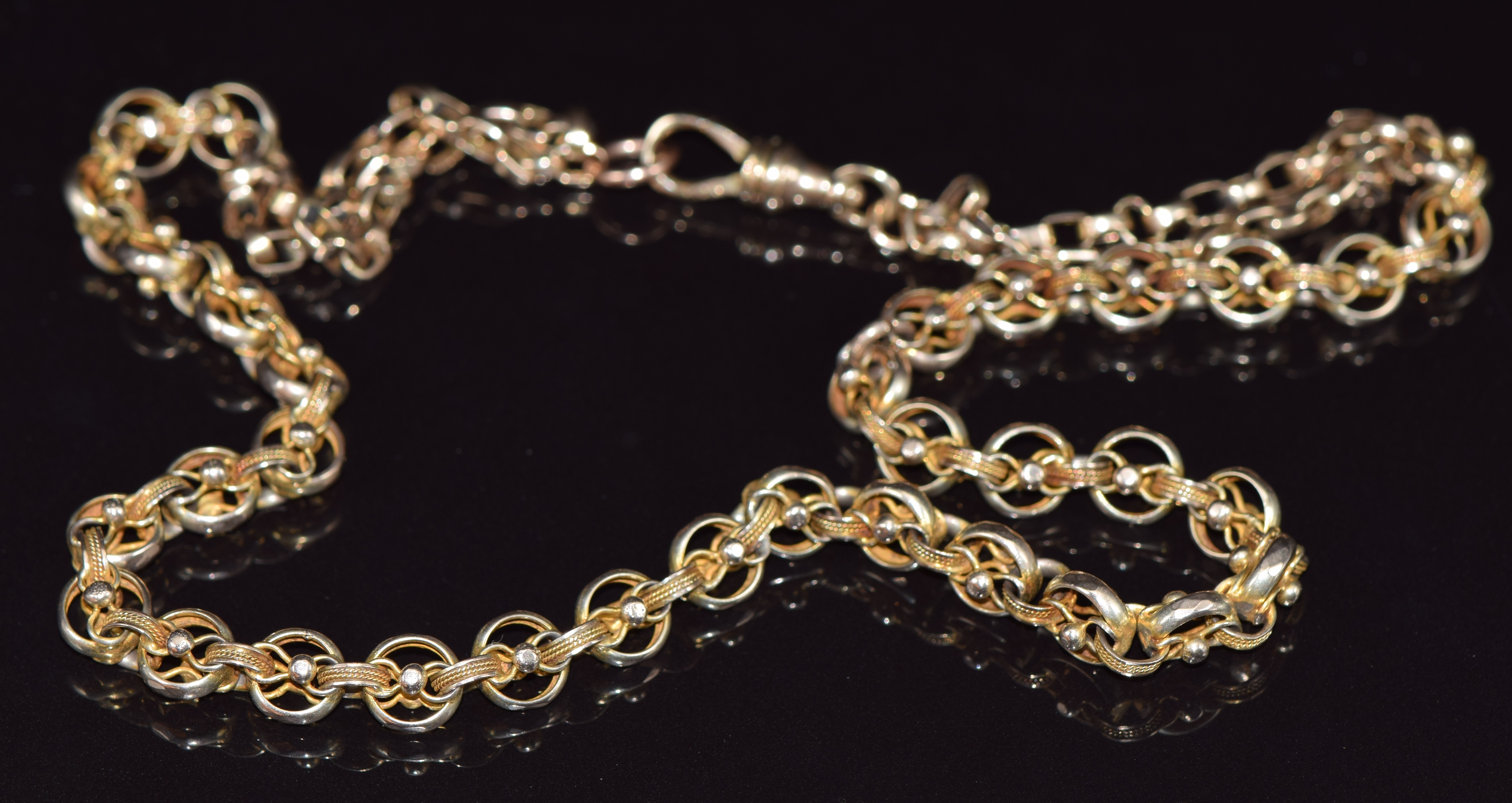 Victorian yellow metal Albert/ fob chain made up of faceted and rope decorated links, 32.2g