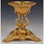 A gilt metal Royalcore centrepiece with relief moulded decoration, raised on fish shaped supports,