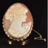 A 9ct gold brooch set with a cameo depicting a young woman