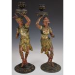 A pair of 19/20thC painted metal figural candlesticks of Indian dancers, H37cm