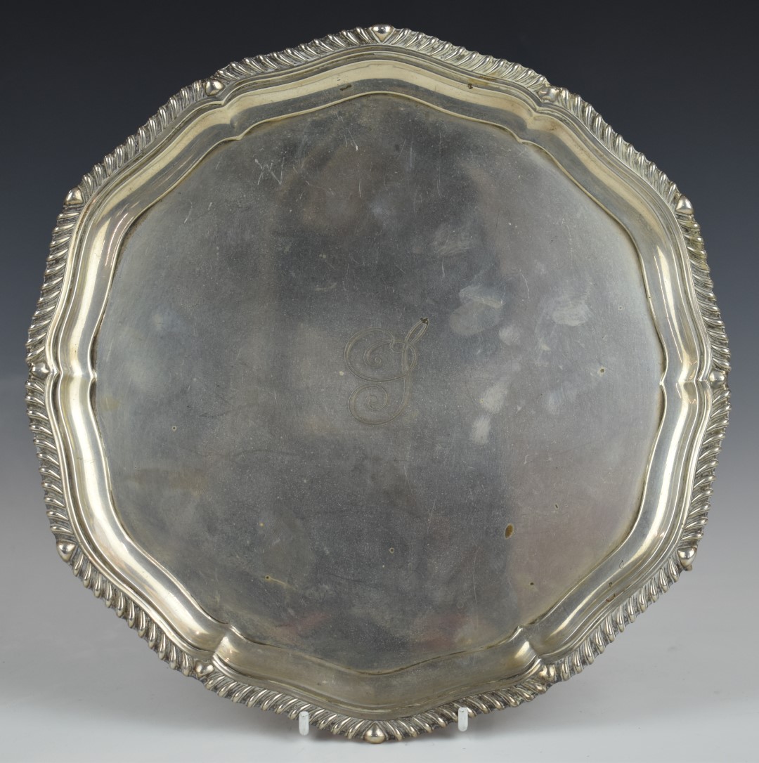 Edward VII hallmarked silver salver with gadrooned edge, raised on three ball and claw feet,