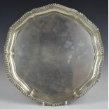 Edward VII hallmarked silver salver with gadrooned edge, raised on three ball and claw feet,