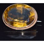 A c1910 9ct gold brooch set with a large oval cut citrine, 9g