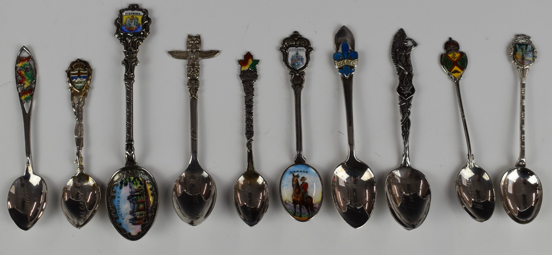 Ten Canadian and American silver souvenir spoons, most with enamel decoration, to include Victoria