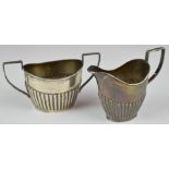 Edward VII hallmarked silver milk jug and sugar bowl with reeded lower bodies, Chester 1901, maker