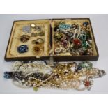 A collection of costume jewellery including French jet brooch, beaded necklaces, vintage earrings,