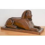 Art Deco Egyptian revival brass inlaid mahogany sphinx, the brass eyes set with green malachite