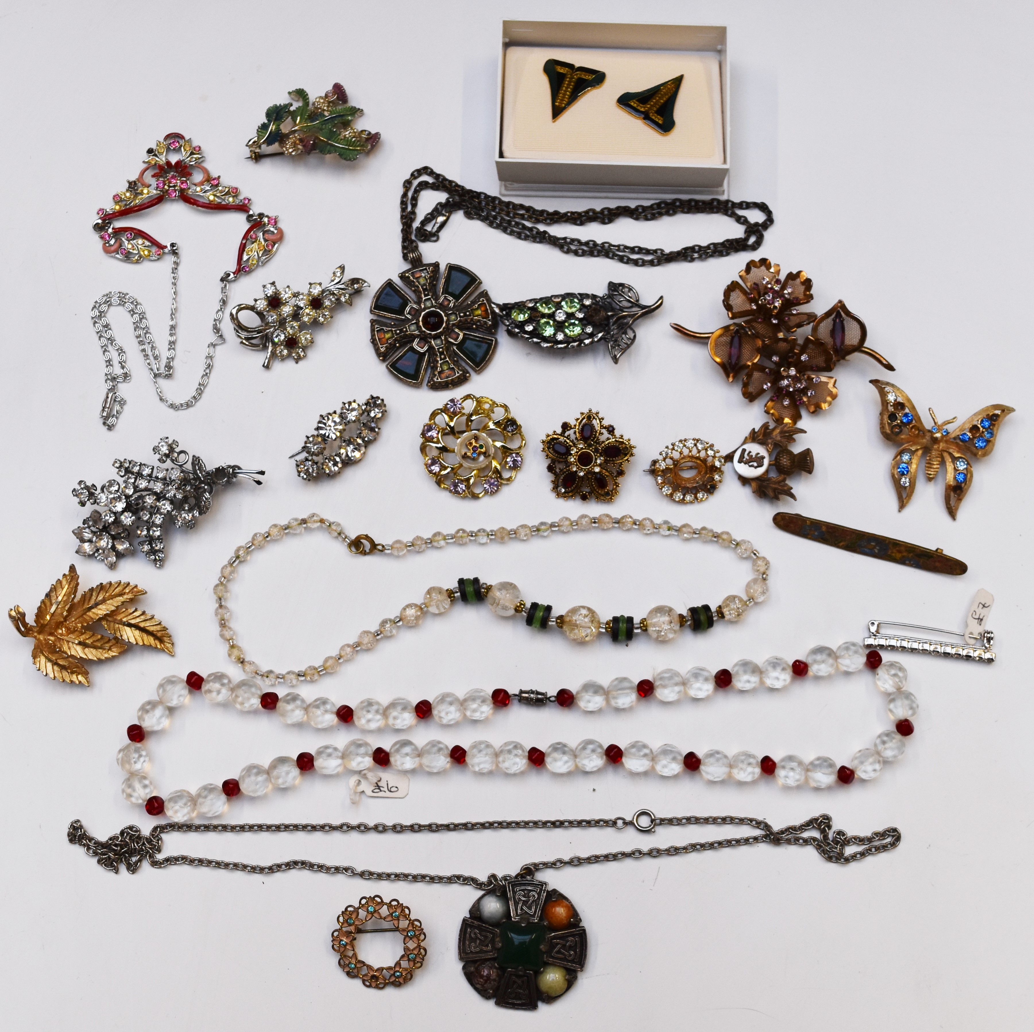 A collection of costume jewellery including Miracle pendants, vintage brooches, silver heart