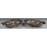Pair of Victorian hallmarked silver baskets with embossed and pierced decoration, Birmingham 1897,
