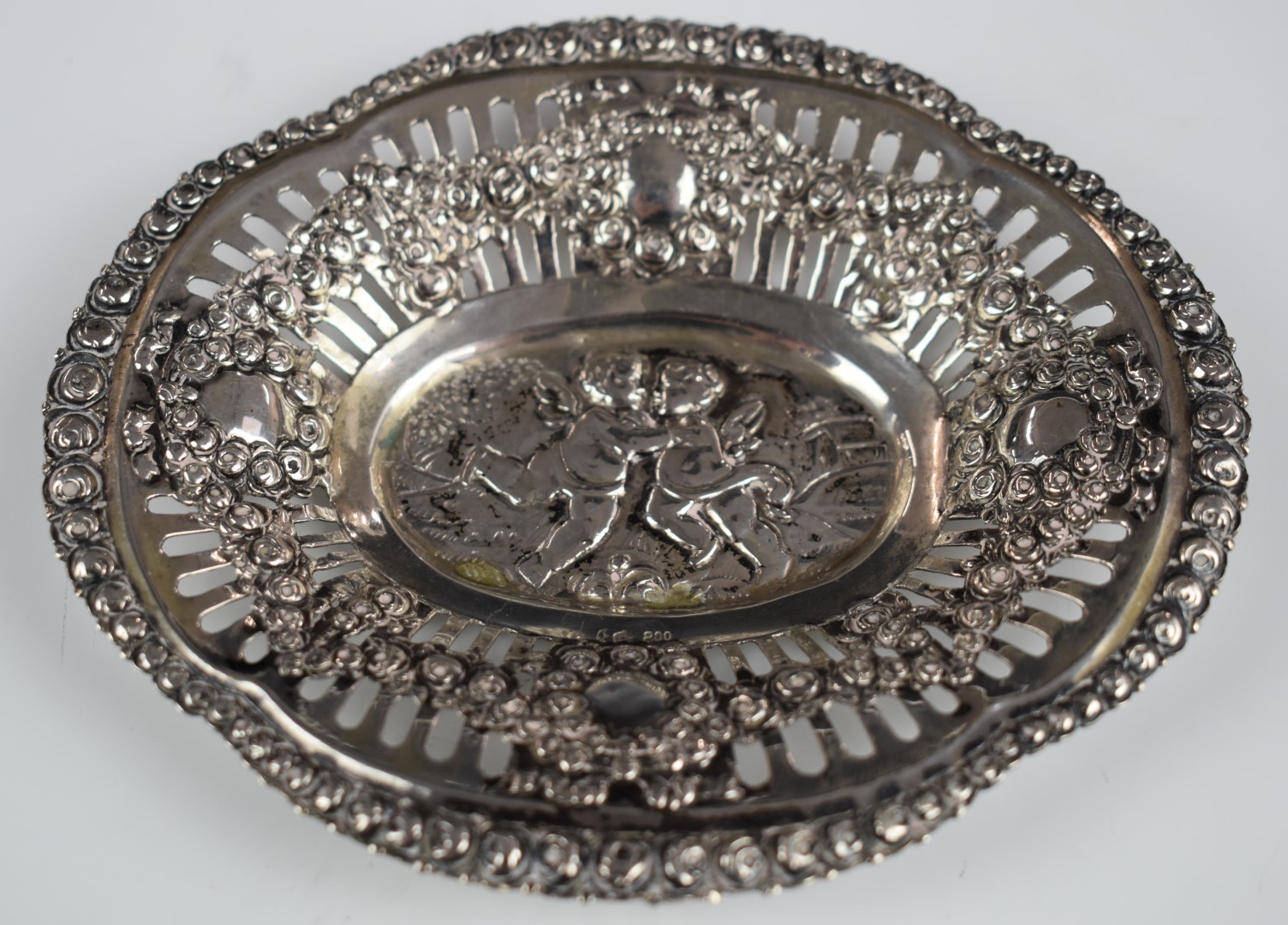 German white metal pin dish with pierced and embossed decoration of cherubs, with German 800 quality