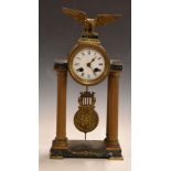 French Empire Portico clock mounted on reeded brass Roman columns and marble base, surmounted by