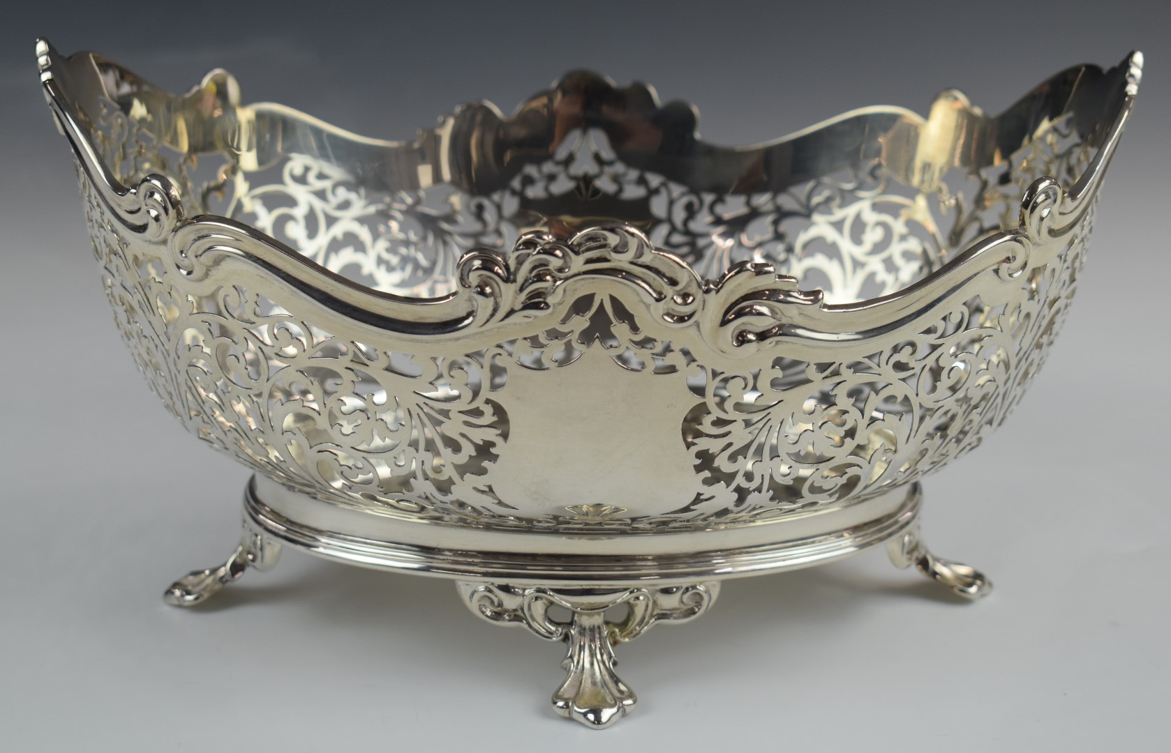 George V hallmarked silver oval bowl with pierced decoration, raised on four feet, Sheffield 1928,