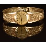 Omega 9ct gold ladies wristwatch with black hands, two-tone baton hour markers, gold dial and signed