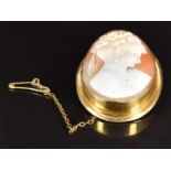 A 9ct gold brooch set with a cameo depicting a young woman