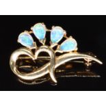 A 9k gold brooch set with pear cut opals, 2.9g