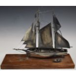 Hallmarked silver model of a sailing boat and tender, London 1980, maker Ammonite Ltd, on wooden