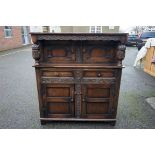 An old oak carved wall cupboard, 127cm wide x 52cm deep x 143cm high.Payment must be made in advance