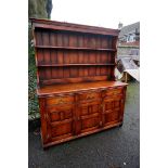 A reproduction oak dresser having rack back, 157cm wide x 52cm deep x 186cm high.Payment must be