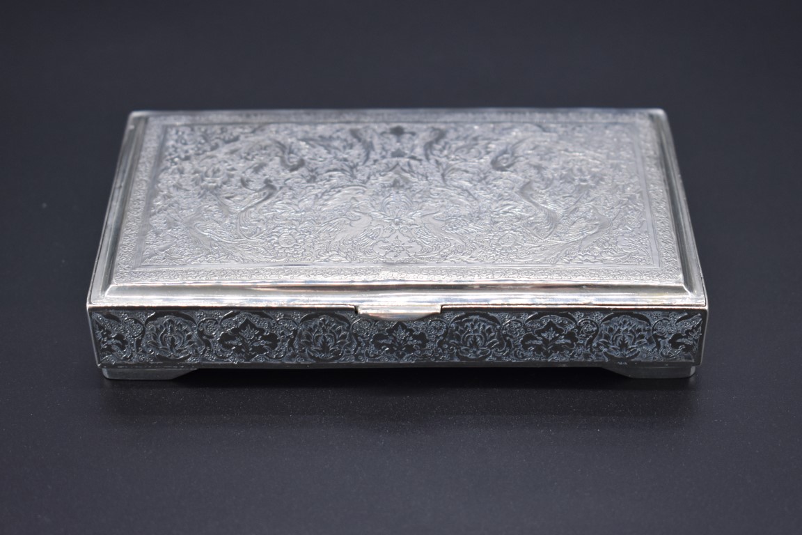 A Persian white metal cigarette box, probably Isfahan, stamped to inner lid, 14cm wide.